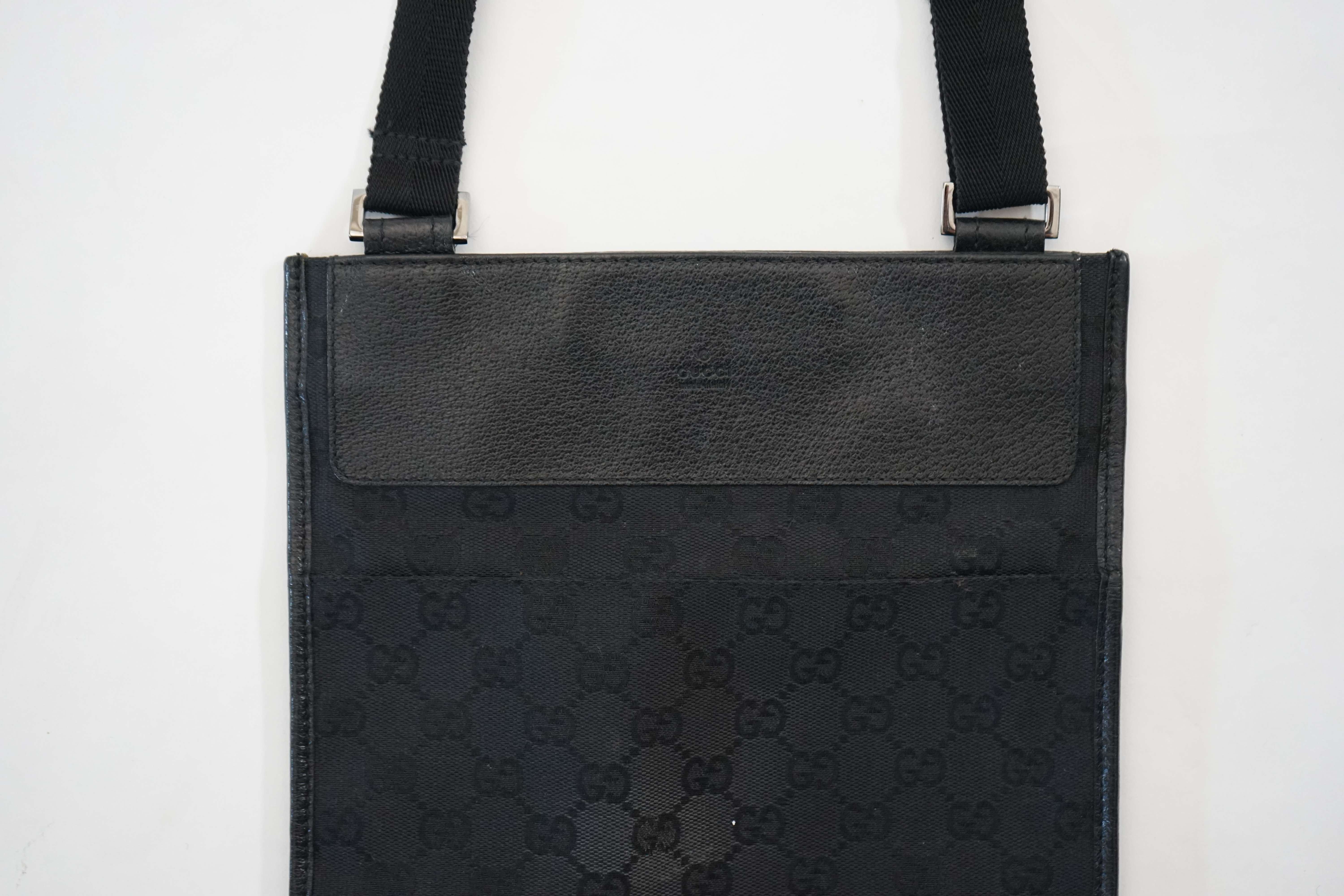 A Gucci black GG canvas crossbody bag Approx width 25cm, depth 1cm, length 24cm, shoulder drop 47cm
